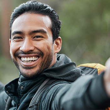 man wearing a blue shirt smiling