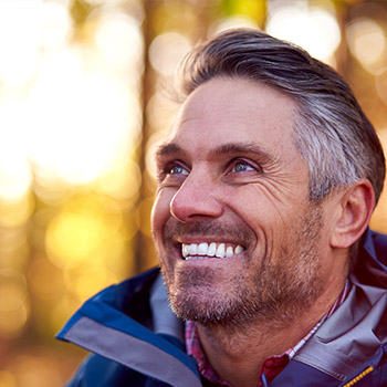 man wearing a red shirt smiling